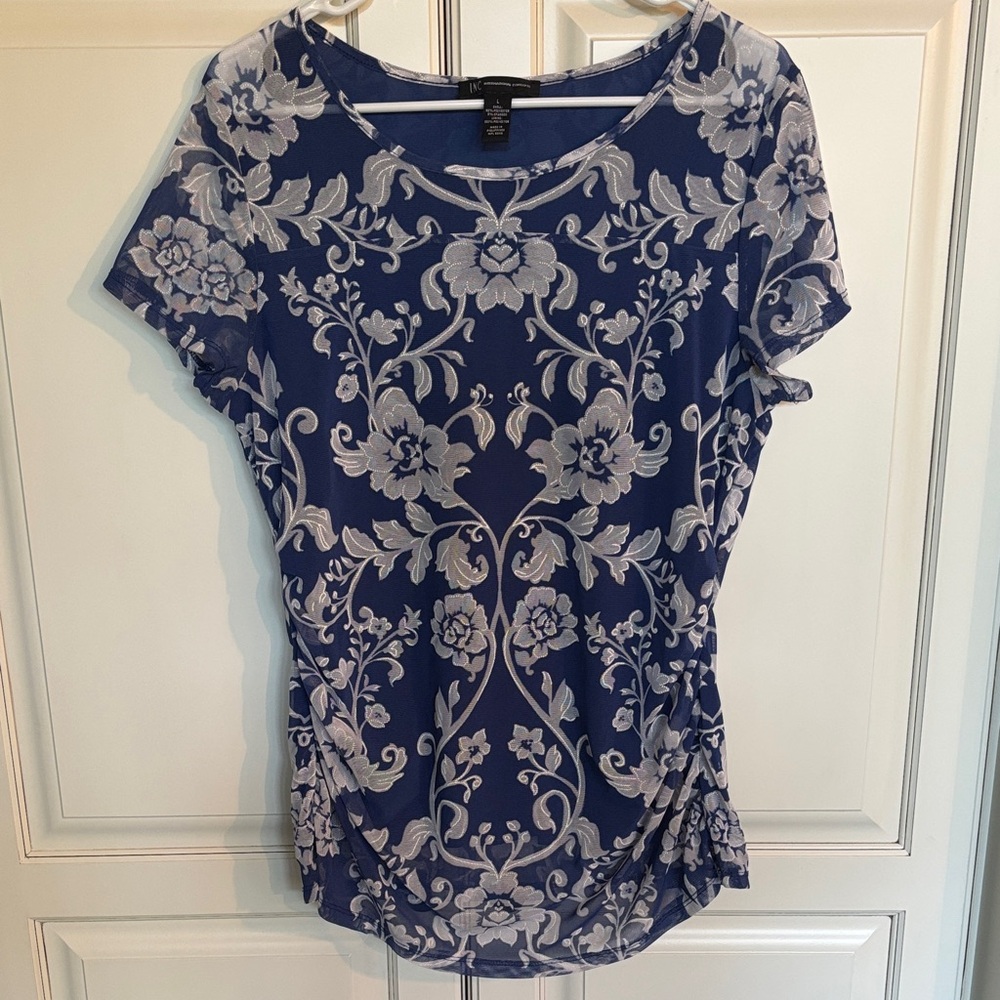INC beautiful, royal blue and white floral blouse. Sheer sleeves and neck line.